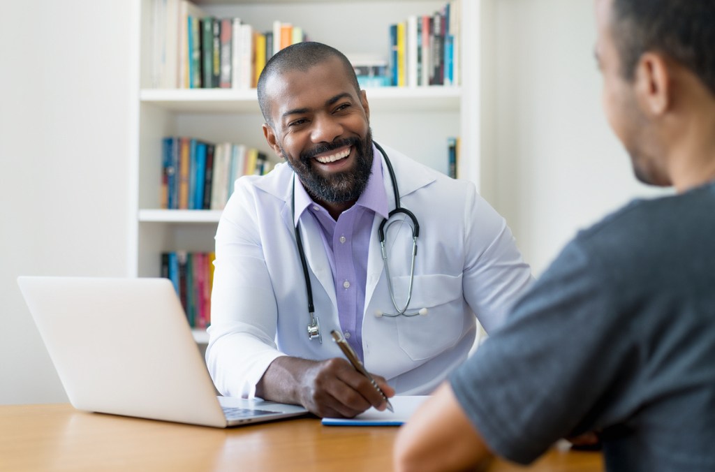 A close-up image shows a person holding a rolled-up certificate of FRCPI with a blue cover and a gold emblem